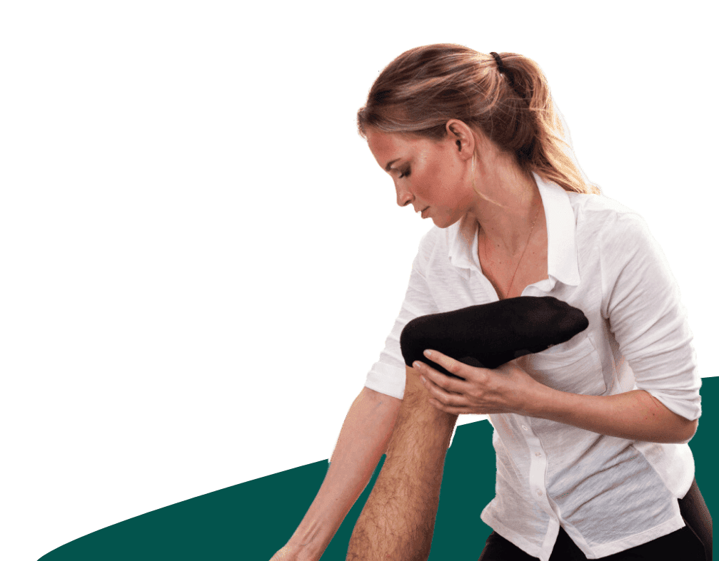 Female therapist giving leg massage to male client