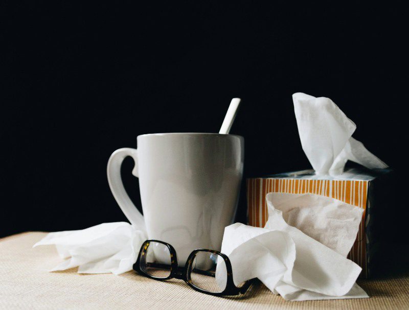 sick with flu Tissue box, cup, and glasses on table